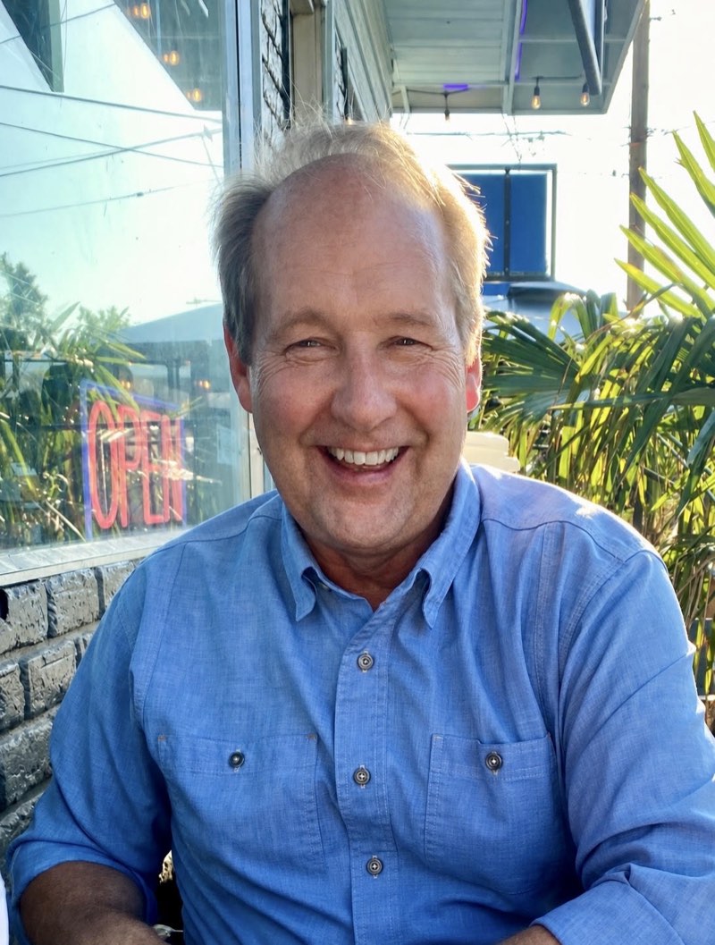 Mark Gustafson, smiling, outdoors in a blue shirt